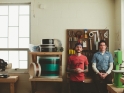 mike-and-scott-at-work-bench-looking-at-camera